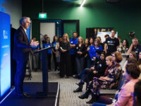 Key note speaker on stage delivering audience address